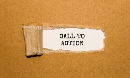 The text Call To Action appearing behind torn brown paperの写真素材