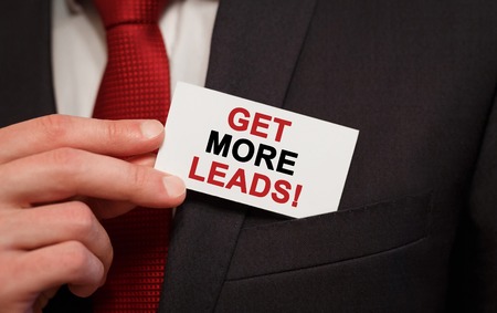 Businessman putting a card with text Get More Leads in the pocketの写真素材