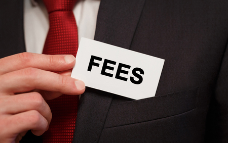 Businessman putting a card with text FEES in the pocketの写真素材