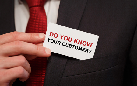 Businessman putting a card with text Do you know your customer in the pocketの写真素材