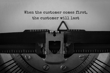 Text When the customer comes first the customer will last typed on retro typewriterの写真素材