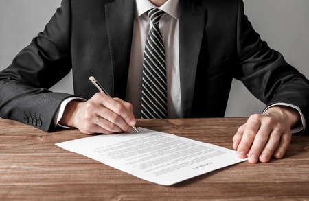 Close up business man signing contract making a deal, business and success conceptの写真素材