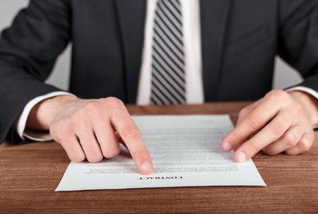 Close up of businessman reading contract. Conceptの写真素材