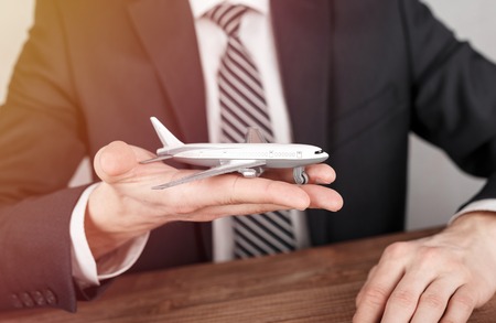Airplane model in hands of a man.の写真素材