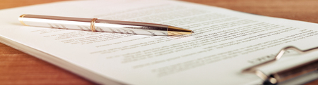 Pen lying on a contract or application form, wide angle view.の写真素材