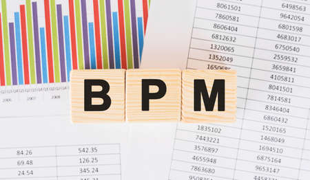 BPM word written on wood block. Faqs text on tableの写真素材