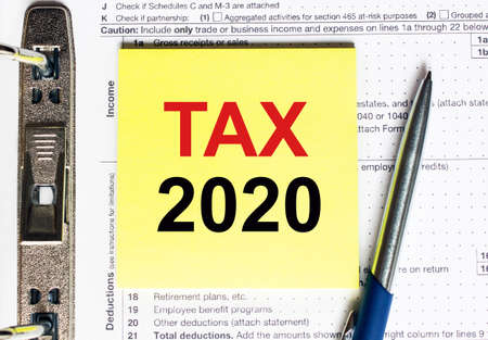 Yellow paper with text Tax 2020, conceptの写真素材