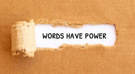 Text Worlds Have Power appearing behind torn brown paper, conceptの写真素材