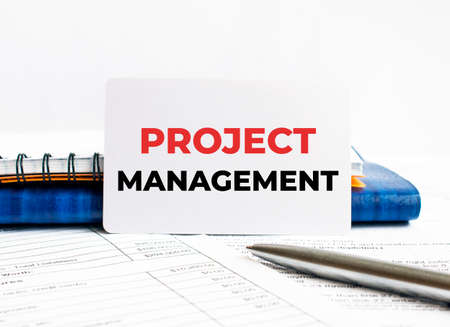 Business card with text Project Management lying on blue notebook, conceptの写真素材