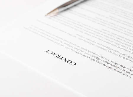 Pen lying on a contract or application form.の写真素材