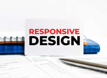Business card with text RESPONSIVE DESIGN lying on blue notebook.の写真素材