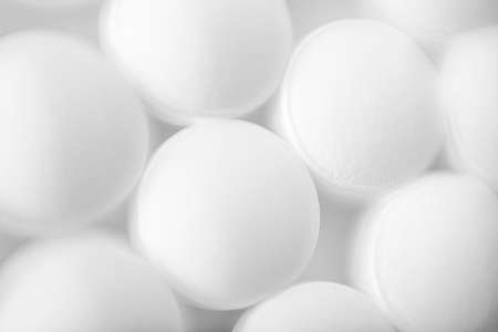 Image of white pills on white background. Medicine concept