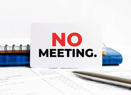 Business card with text No meeting lying on blue notebook.の写真素材