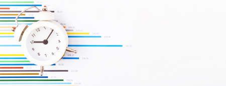 Clock on business charts and graphs. Business planning, accounting, analysis, financial planning and...