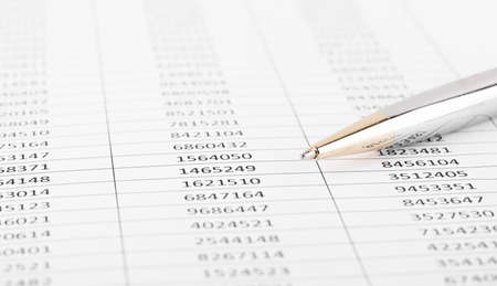 Pen with Financial accounting graphs. Finance, business and accounting concept