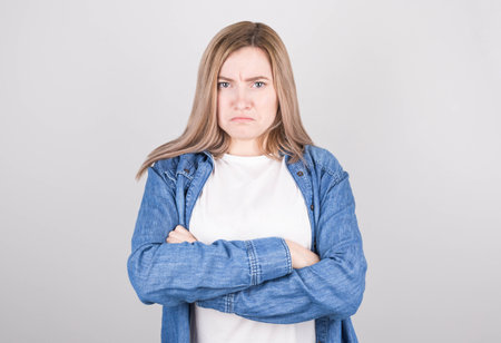 Resentful unhappy casual woman looking down. Toned closeup portrait.の写真素材