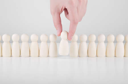 Successful team leader. Businessman hand choose people standing out from the crowd. Human resources...
