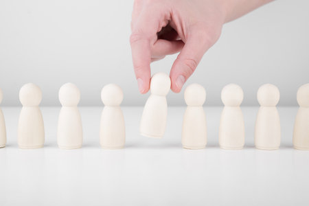 Successful team leader. Businessman hand choose people standing out from the crowd. Human resources and CEO conceptの写真素材