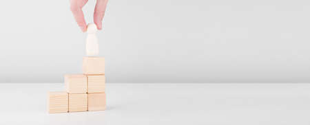 Businessman hold wooden man representing leader steps up success with standing on top of staircase....