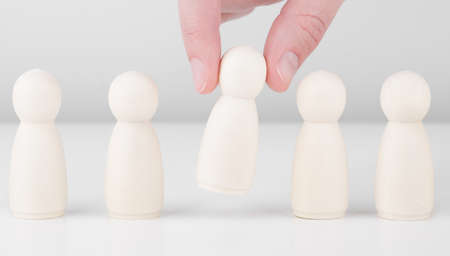 Successful team leader. Businessman hand choose people standing out from the crowd. Human resources...