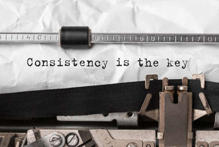 Text Consistency is the key typed on retro typewriterの写真素材