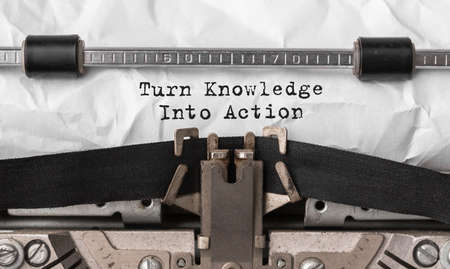 Text Turn Knowledge Into Action typed on retro typewriterの写真素材