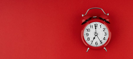 Red alarm clock on a red background. top view.の写真素材