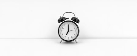 Black alarm clock on white background