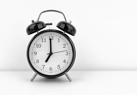 Black alarm clock on white backgroundの写真素材