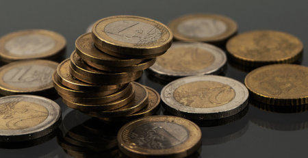 Stacks of coins on a black backgroundの写真素材