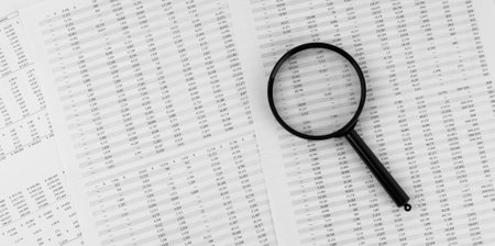 Magnifying glass on financial statement.の写真素材