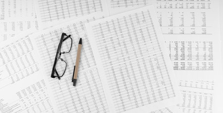 Eye glasses with pen on financial statement.の写真素材