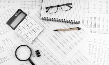 Calculator, magnifying glass, pen, eye glasses lying on financial statement. financial concept. top view.の写真素材