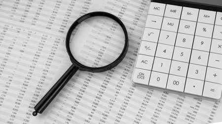 Calculator and magnifying glass on financial statement. Financial, accounting and business concept.の写真素材