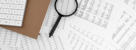 Calculator, magnifying glass lying on financial documents . financial concept.の写真素材