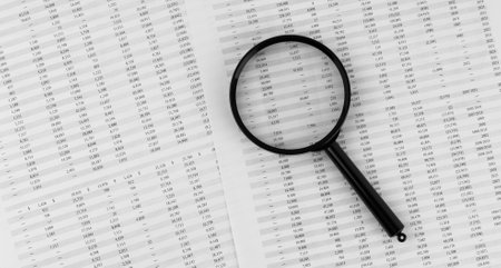 Magnifying glass on financial statement.の写真素材