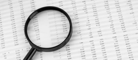 Calculator and magnifying glass on financial documents. financial concept.の写真素材