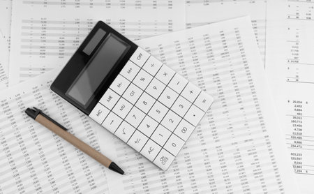 Calculator with pen on financial statement.の写真素材