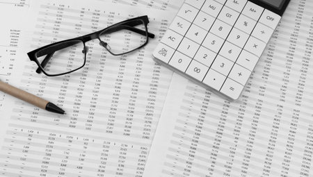 Calculator, pen and eye glasses on financial documents. top view.の写真素材