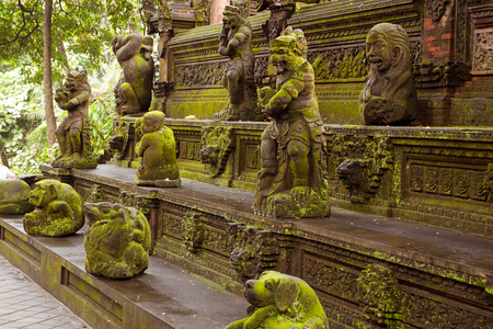 Statues covered in green moss on Monkey Forest Ubud, Baliの写真素材