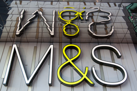 Westfield Stratford City, London/England - October 26 2011: The Marks & Spencer logo reflects in glass at Westfield Stratford City mall.のeditorial素材
