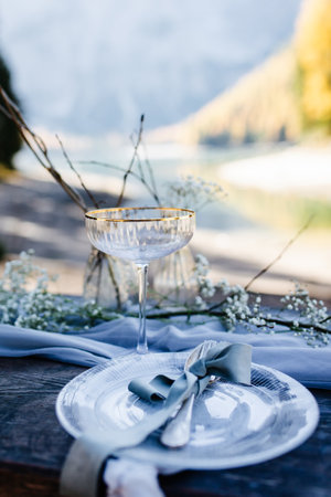 Beautiful table setting on the bank of a mountain lake. Selective focus.の写真素材