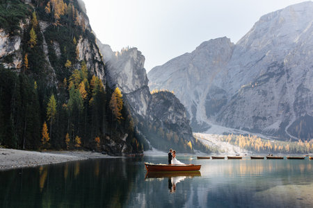 Beautiful couple in a boat on the lake Braies, Italyの写真素材