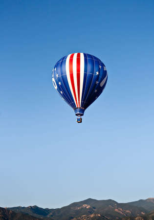 An American flag themed balloon rise in the Colorado sky の写真素材