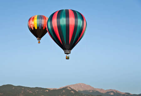 A hot air balloon ascends in the skies above Pikes Peak during the 2011 Colorado Balloon Classicの写真素材