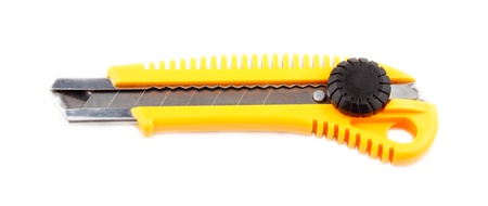 Yellow stationery knife isolated