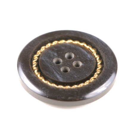 Old black button isolated on white background