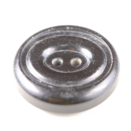 Old black button isolated on white backgroundの写真素材