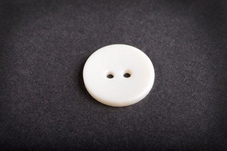 Old white button isolated on white background