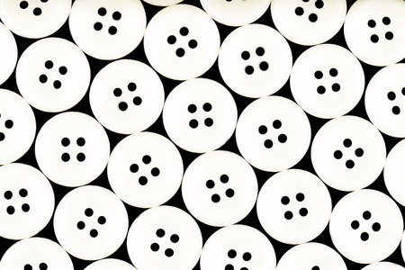 White buttons isolated on black backgroundの写真素材